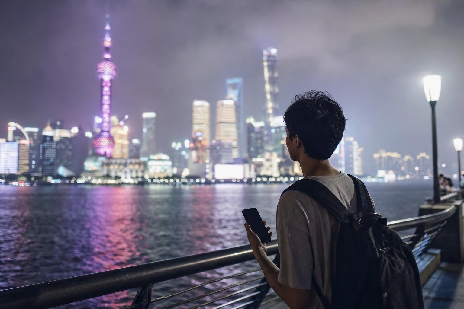 Illustration: a traveller with a phone on a riverside promenade at night, a modern city skyline across the water.